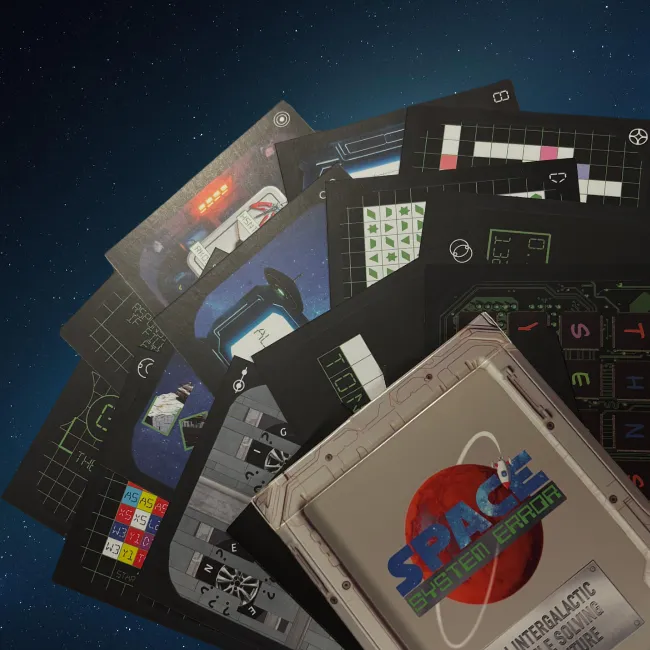 A fan of sci-fi puzzle cards — alien glyph grids, a control panel and a spacewalk illustration — beside the Space: System Error box