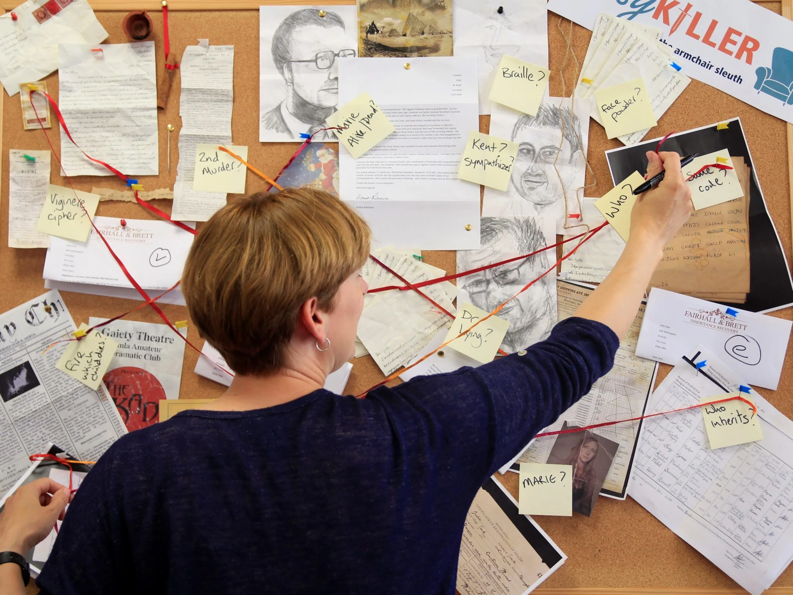 An investigator pinning suspect portraits to an evidence board, the Cosykiller logo visible in the corner
