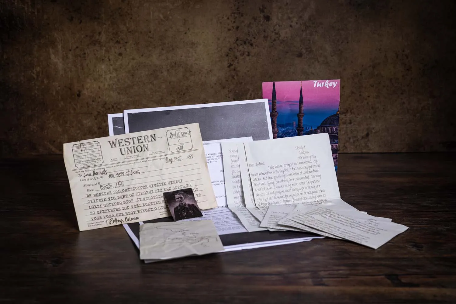 A Western Union telegram beside a Turkey postcard and a bundle of handwritten letters — how messages used to arrive